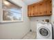 Laundry room with wood cabinets and tile floor at 12071 Claremont Dr, Port Charlotte, FL 33981