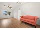 Living room with hardwood floors and coral sofa at 12071 Claremont Dr, Port Charlotte, FL 33981