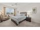 Guest bedroom with striped bedding and a ceiling fan at 14150 Poppy Field Loop # 4322, Punta Gorda, FL 33955