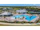 Aerial view of community pool, clubhouse, and tennis courts at 14150 Poppy Field Loop # 4322, Punta Gorda, FL 33955