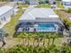 House with pool and screened enclosure, surrounded by palm trees at 14303 Maysville Cir, Port Charlotte, FL 33981