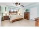 Bedroom with king-size bed and ceiling fan at 14303 Maysville Cir, Port Charlotte, FL 33981