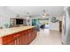 Kitchen with granite island, stainless steel appliances, and view of living room at 14303 Maysville Cir, Port Charlotte, FL 33981