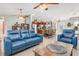 Open living space with blue couches and a view of the kitchen at 14303 Maysville Cir, Port Charlotte, FL 33981