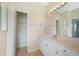 Bathroom features a vanity, linen closet, and mirror at 1431 Aqui Esta Dr # 221, Punta Gorda, FL 33950