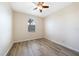 Bedroom featuring wood-look floors and a window with blinds at 1431 Aqui Esta Dr # 221, Punta Gorda, FL 33950