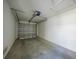 Empty garage with overhead door and concrete floor at 1431 Aqui Esta Dr # 221, Punta Gorda, FL 33950