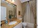 Bathroom with granite countertop and patterned shower curtain at 1447 Red Oak Ln, Port Charlotte, FL 33948