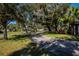 Landscaped community with mature trees and a winding path at 1447 Red Oak Ln, Port Charlotte, FL 33948