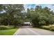 Road leading to the community entrance at 1447 Red Oak Ln, Port Charlotte, FL 33948