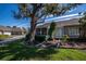 Home's exterior showcasing a screened patio and lush landscaping at 1447 Red Oak Ln, Port Charlotte, FL 33948