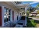 Inviting front porch with red shutters and a view of the landscaped yard at 1447 Red Oak Ln, Port Charlotte, FL 33948