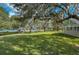 Relaxing gazebo by the lake with lush landscaping at 1447 Red Oak Ln, Port Charlotte, FL 33948