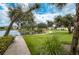 Scenic walkway along the lake with green grass at 1447 Red Oak Ln, Port Charlotte, FL 33948