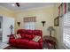 Sitting area with red leather couch and side table at 1447 Red Oak Ln, Port Charlotte, FL 33948