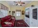 Sitting room with red leather couch, built-in shelving, and TV at 1447 Red Oak Ln, Port Charlotte, FL 33948