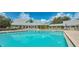 Inviting community pool reflecting the building at 1447 Red Oak Ln, Port Charlotte, FL 33948