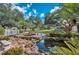 Peaceful water feature with benches and landscaping at 1447 Red Oak Ln, Port Charlotte, FL 33948