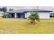 Large backyard with grassy area and palm tree at 1612 Nuremberg Blvd, Punta Gorda, FL 33983