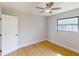 Well-lit bedroom featuring hardwood floors and ceiling fan at 1612 Nuremberg Blvd, Punta Gorda, FL 33983