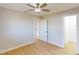 Bright bedroom with wood floors, ceiling fan, and access to private patio at 1612 Nuremberg Blvd, Punta Gorda, FL 33983