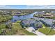 An aerial view of a single-Gathering home on the waterfront with a large backyard at 18138 Eau Gallie Cir, Port Charlotte, FL 33948