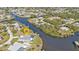 Aerial view showcasing a waterfront property, private dock, and canal access at 18138 Eau Gallie Cir, Port Charlotte, FL 33948