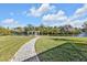 Spacious backyard with a paver walkway leading to the waterfront at 18138 Eau Gallie Cir, Port Charlotte, FL 33948