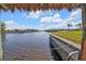 Scenic view of the canal from under a tiki hut at 18138 Eau Gallie Cir, Port Charlotte, FL 33948