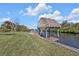 Relaxing waterfront dock with a thatched roof gazebo at 18138 Eau Gallie Cir, Port Charlotte, FL 33948