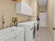 Laundry room with washer, dryer, and utility sink at 18138 Eau Gallie Cir, Port Charlotte, FL 33948