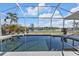 Inviting pool with screened enclosure offering tranquil water views at 18138 Eau Gallie Cir, Port Charlotte, FL 33948