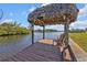 Enjoy the view from this relaxing dock with a thatched roof at 18138 Eau Gallie Cir, Port Charlotte, FL 33948