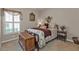 Charming bedroom with floral bedding, window shutters, and a wooden storage chest at 2110 Royal Tern Cir, Punta Gorda, FL 33983