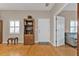 Light and airy entryway with hardwood floors, wooden shelving and a view into the living room at 2110 Royal Tern Cir, Punta Gorda, FL 33983