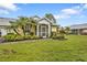 Bright yellow house with a screened porch and well-manicured lawn at 2110 Royal Tern Cir, Punta Gorda, FL 33983