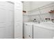 Bright laundry room with washer, dryer, and shelving at 2110 Royal Tern Cir, Punta Gorda, FL 33983