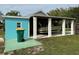 Covered carport with a teal exterior wall and a boat parked inside at 2115 Myrtle Ave, Punta Gorda, FL 33950