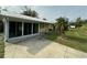 Ranch style home with screened porch and a paved driveway at 2115 Myrtle Ave, Punta Gorda, FL 33950