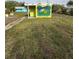 Small building with painted pineapple design and grassy yard at 2115 Myrtle Ave, Punta Gorda, FL 33950