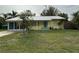 Charming yellow house with a metal roof and a spacious front yard at 2115 Myrtle Ave, Punta Gorda, FL 33950