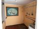 Small laundry area with shelving, water heater, and nautical picture at 2115 Myrtle Ave, Punta Gorda, FL 33950