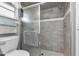 Modern gray tiled shower with glass enclosure at 22259 Priscilla Ave, Port Charlotte, FL 33954