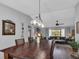 Dining area with a rustic wooden table and a view into the living room at 22259 Priscilla Ave, Port Charlotte, FL 33954