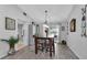 Bright dining room with a wooden table, six chairs, and access to the backyard at 22259 Priscilla Ave, Port Charlotte, FL 33954