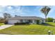 Single-story house with a spacious lawn and driveway at 22259 Priscilla Ave, Port Charlotte, FL 33954