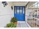 Bright blue front door with sidelights and decorative metalwork at 22259 Priscilla Ave, Port Charlotte, FL 33954