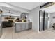 Modern kitchen island with gray cabinets and a barn door at 22259 Priscilla Ave, Port Charlotte, FL 33954