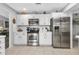 Modern kitchen with white cabinets, stainless steel appliances, and granite countertops at 22259 Priscilla Ave, Port Charlotte, FL 33954