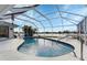 Inviting kidney-shaped pool with screened enclosure at 22259 Priscilla Ave, Port Charlotte, FL 33954